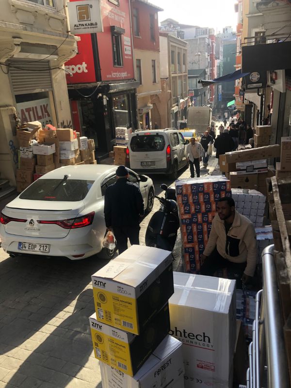 Delivery trucks blocking traffic, delivered boxes blocking sidewalks