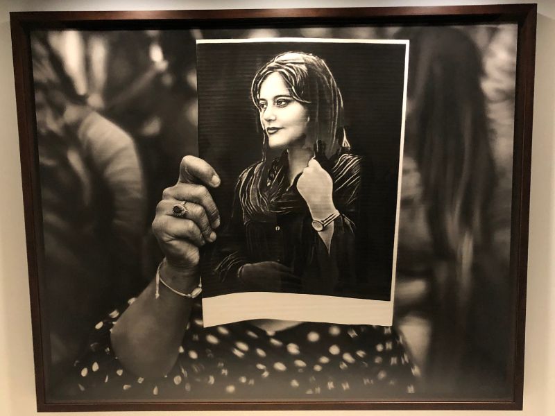 3 From the Louisiana Museum: "In 2022, Mahsa Amini, a 20-year-old Iranian woman, was killed by the morality poolice in Tehran for allegedly not wearing her headscarf properly. This picture was taken at the country's embassy in Brussels. A female protester holds Amini's portrait in front of her face - perhaps she has roots in the slain woman's homeland; we cannot be sure. Printed on an A4 sheet of paper, the portrait of Amini resembles a religious icon. Highlighting the power of photography as a tool of resistance, Longo gives visibility to Amini in the face of the brutal repression in Iran."