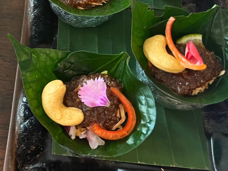 ...Savoury leaf wraps: Blend of coconut, ginger, fresh bitter leaves, peanuts, lime and chilli