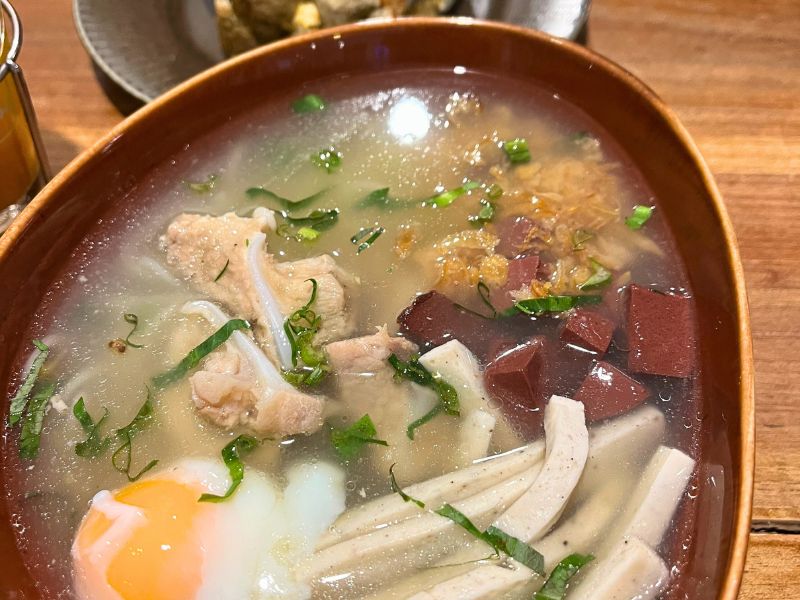 Guay Jub (Thai-Chinese Rolled Noodle Soup): pork meatballs, pork blood jelly, Vietnamese pork sausage, crispy shallots, onsen egg, corriander, rice noodles ($3)