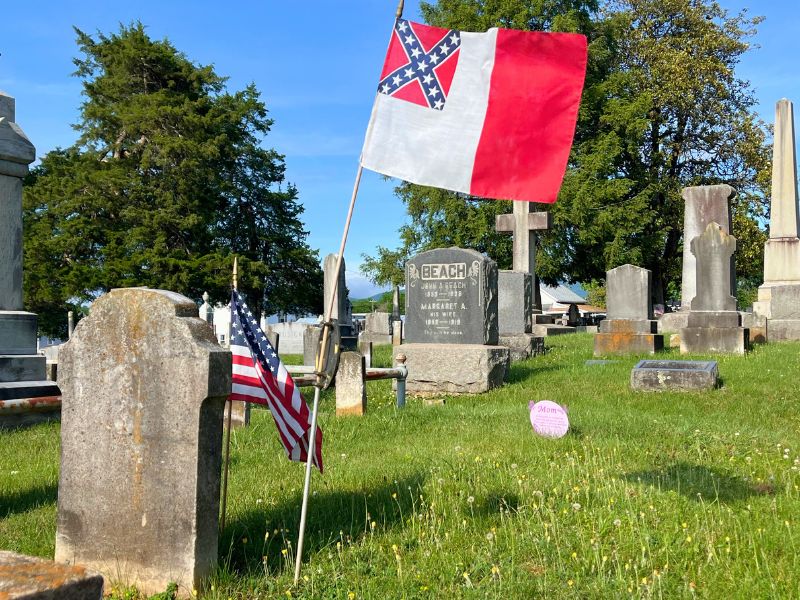 Old conferderate/US flags litter the graveyard